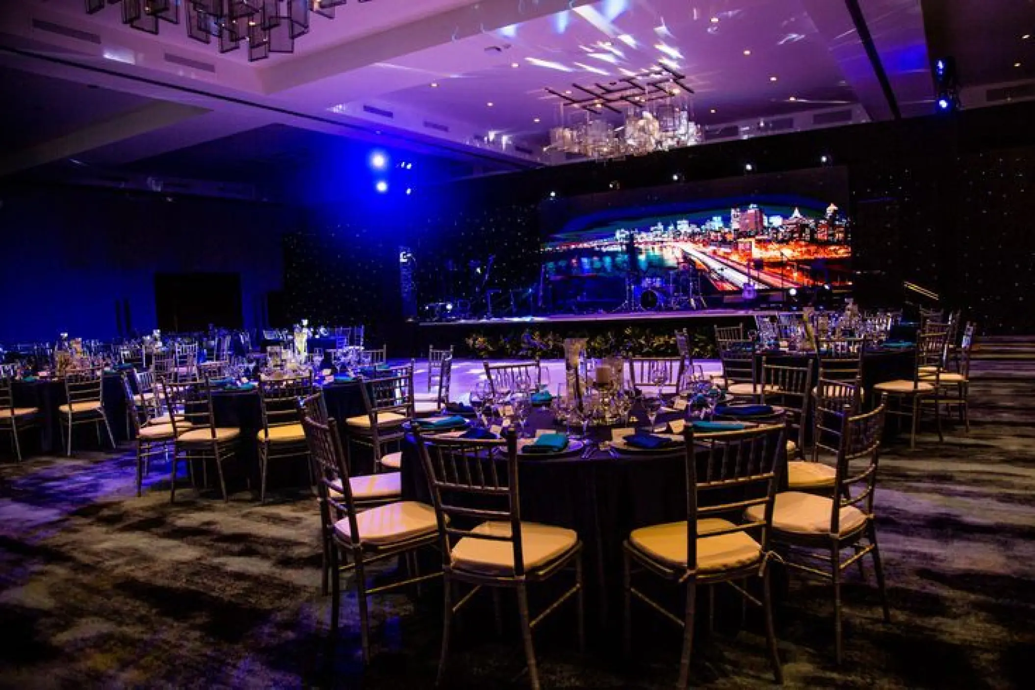 Indoor wedding reception with purple lighting in the ballroom at Secrets Cap Cana, Punta Cana