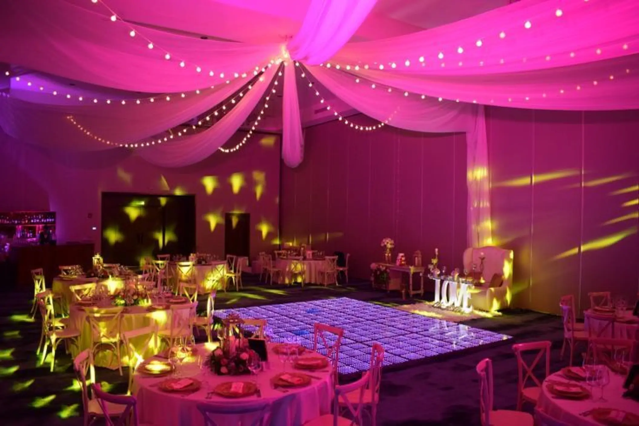 Ballroom wedding reception setup with an illuminated dance floor at Secrets Cap Cana, Punta Cana