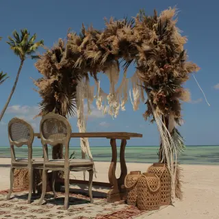 Beachfront wedding ceremony arch with pampas grass and macrame at Secrets Cap Cana, Punta Cana