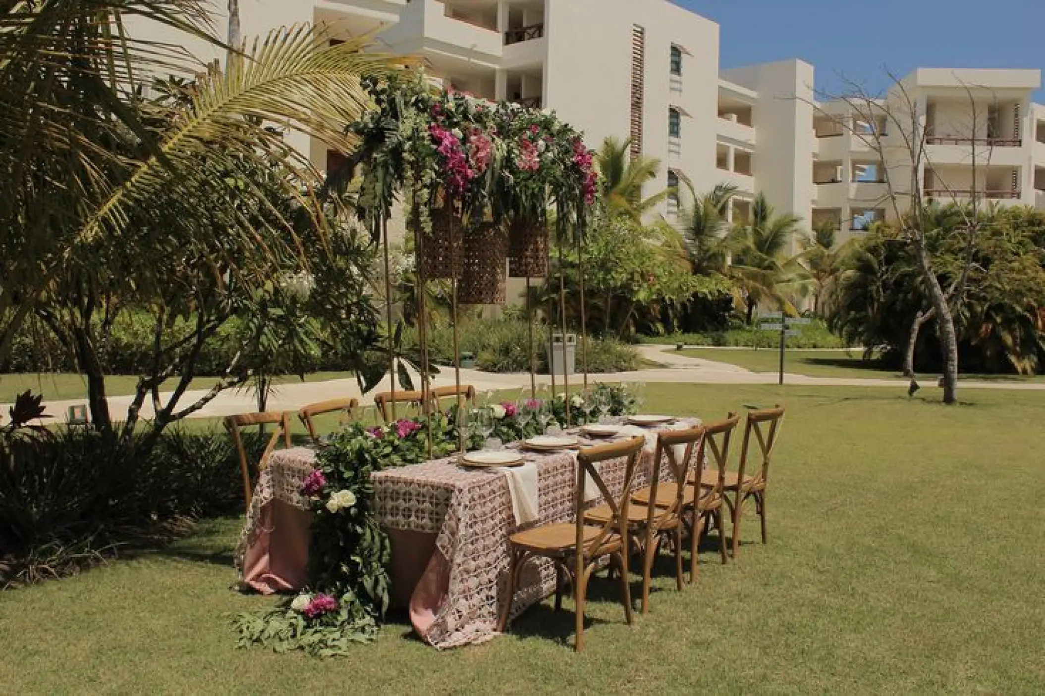 Garden wedding reception table with floral arch at Secrets Cap Cana, Punta Cana