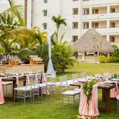 Outdoor wedding reception setup on the lawn at Secrets Cap Cana, Punta Cana