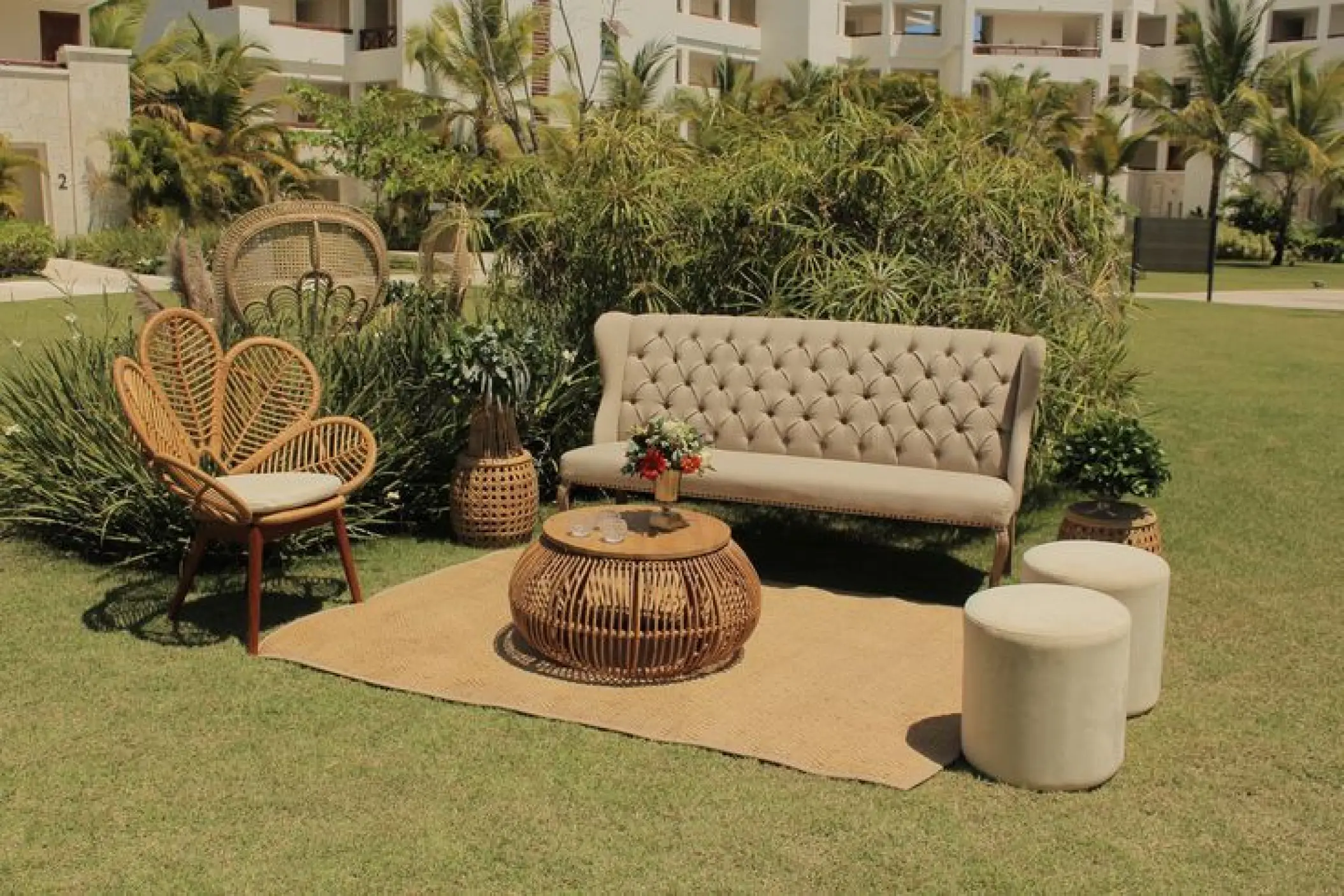 Tufted sofa and wicker chairs for a tropical lounge wedding reception at Secrets Cap Cana, Punta Cana