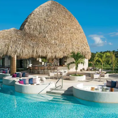 Thatched roof poolside lounge with circular seating at Secrets Cap Cana, Punta Cana