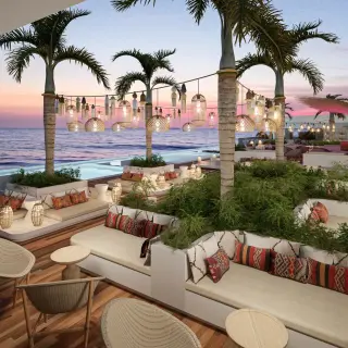Rooftop lounge with palm trees and ocean views at Impression Isla Mujeres by Secrets