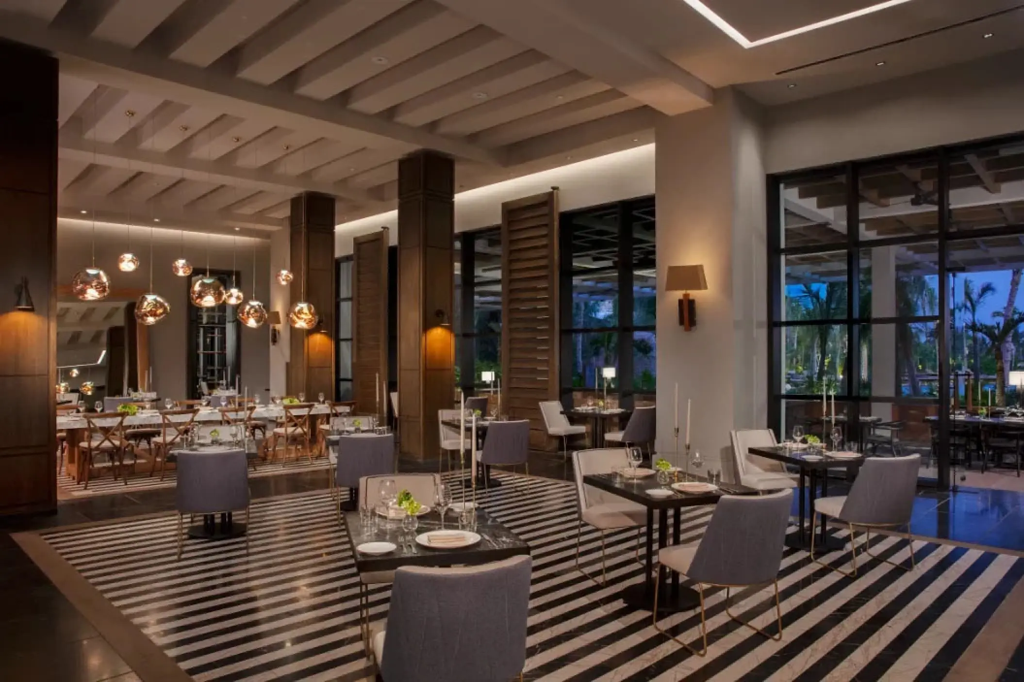 Allora restaurant interior with modern lighting and striped flooring at Secrets Moxche, Playa Del Carmen