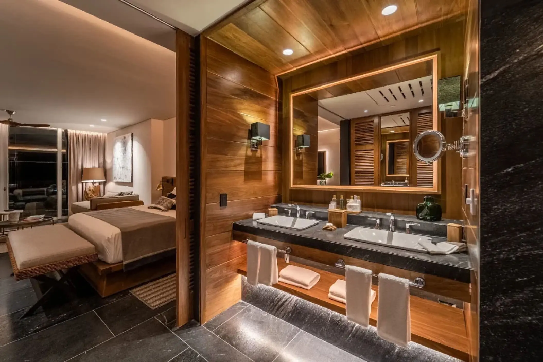 Modern wood-paneled bathroom and double vanity in a guest suite at Secrets Moxche, Playa Del Carmen