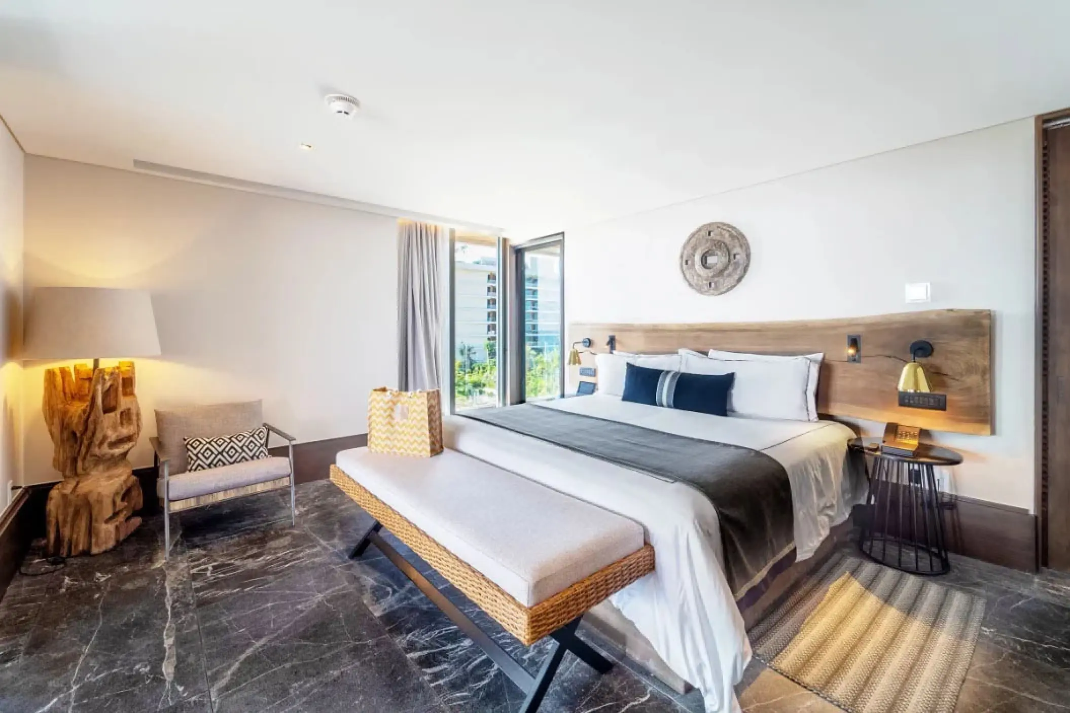 Modern master suite with wood accents and a private balcony at Secrets Moxche, Playa Del Carmen