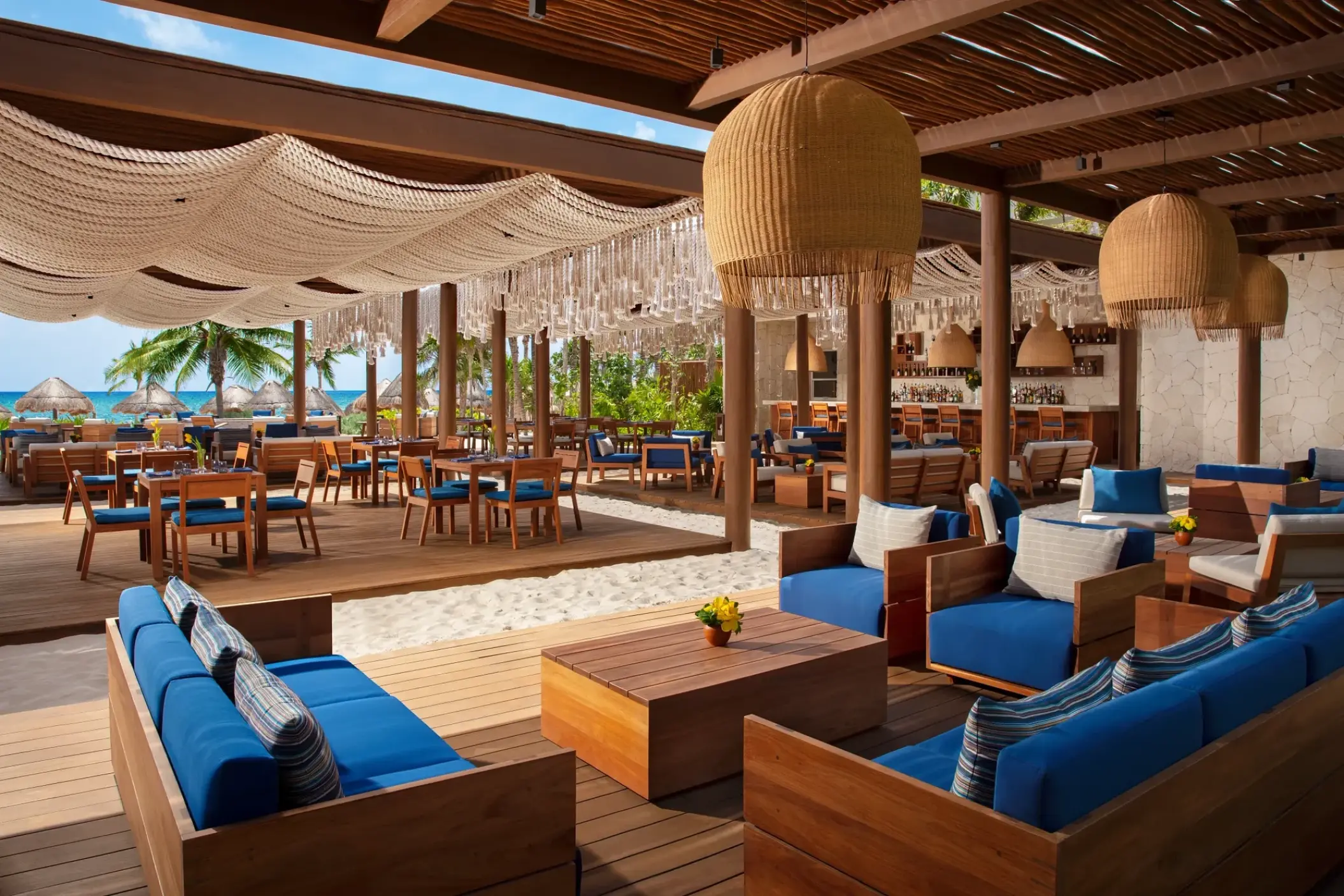 Secrets Maroma Beach Preferred Club lounge with blue seating and woven decor, Riviera Maya