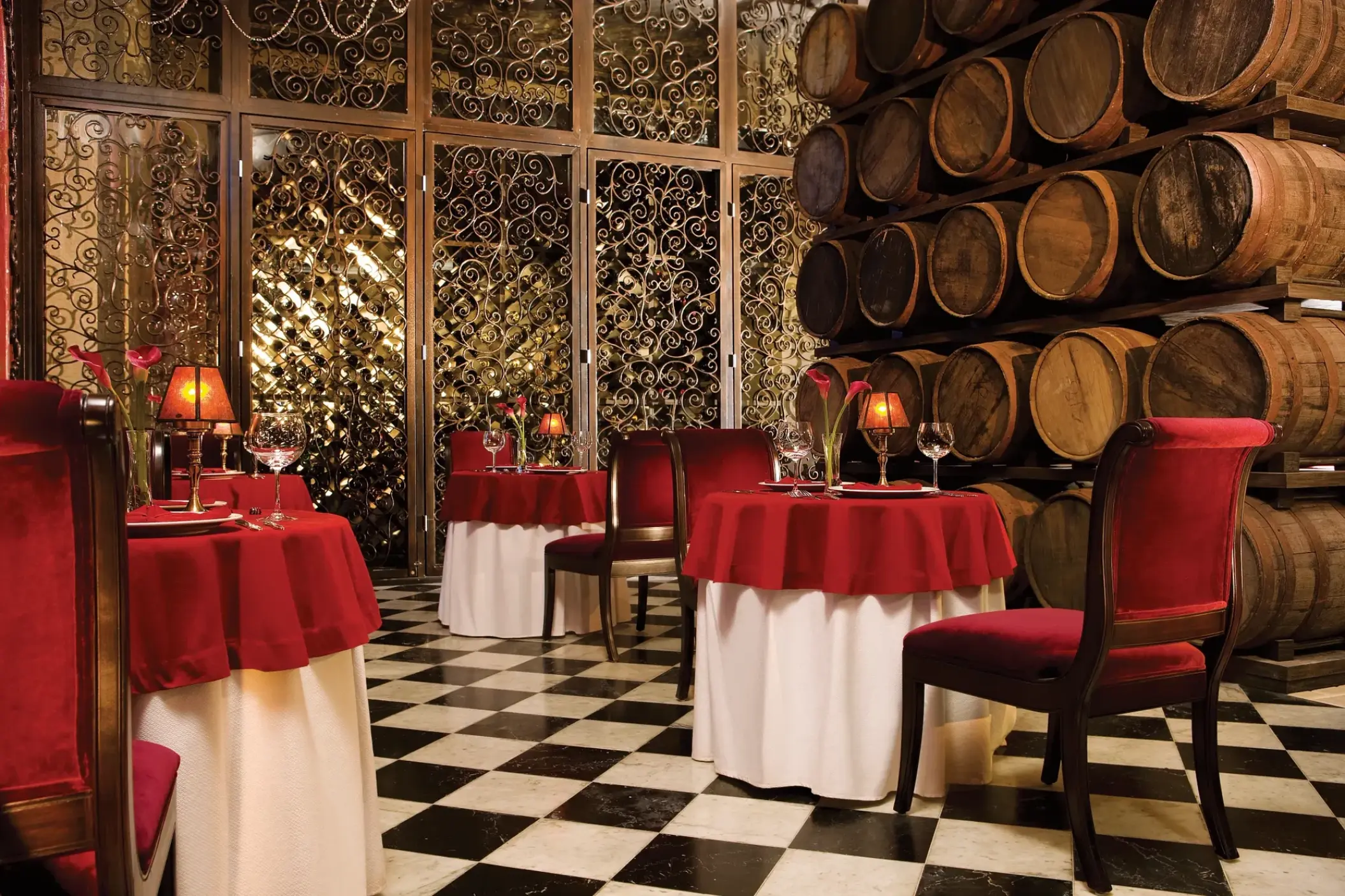 Bordeaux restaurant with wine barrels and red velvet chairs at Secrets Maroma Beach, Riviera Maya
