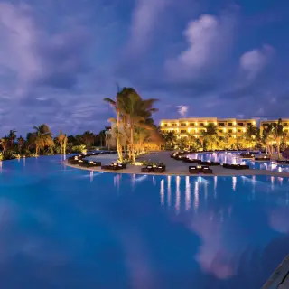 Illuminated infinity pool at night at Secrets Maroma Beach, Riviera Maya