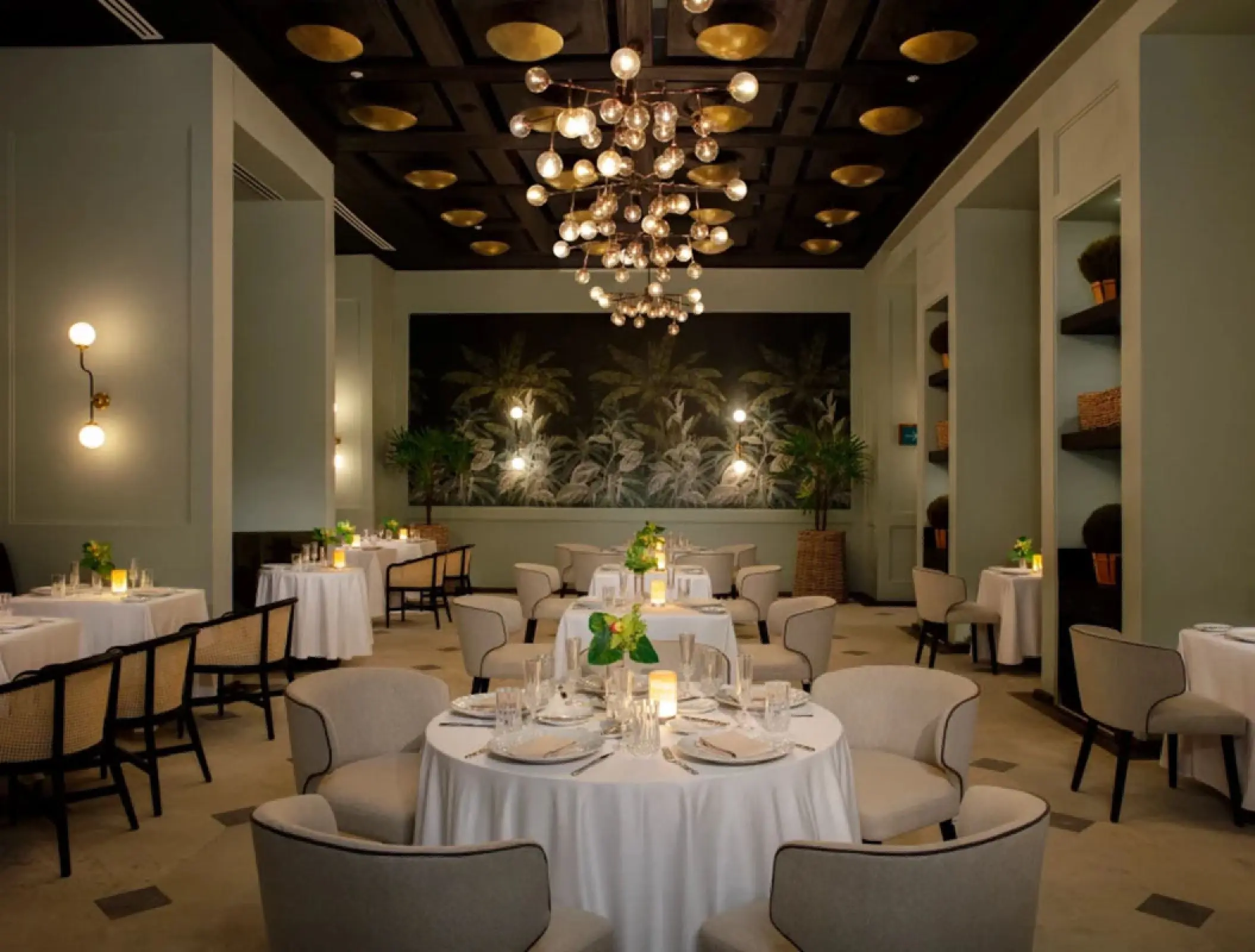 Bisou French restaurant with white tablecloths and modern lighting at Secrets Moxche, Playa Del Carmen