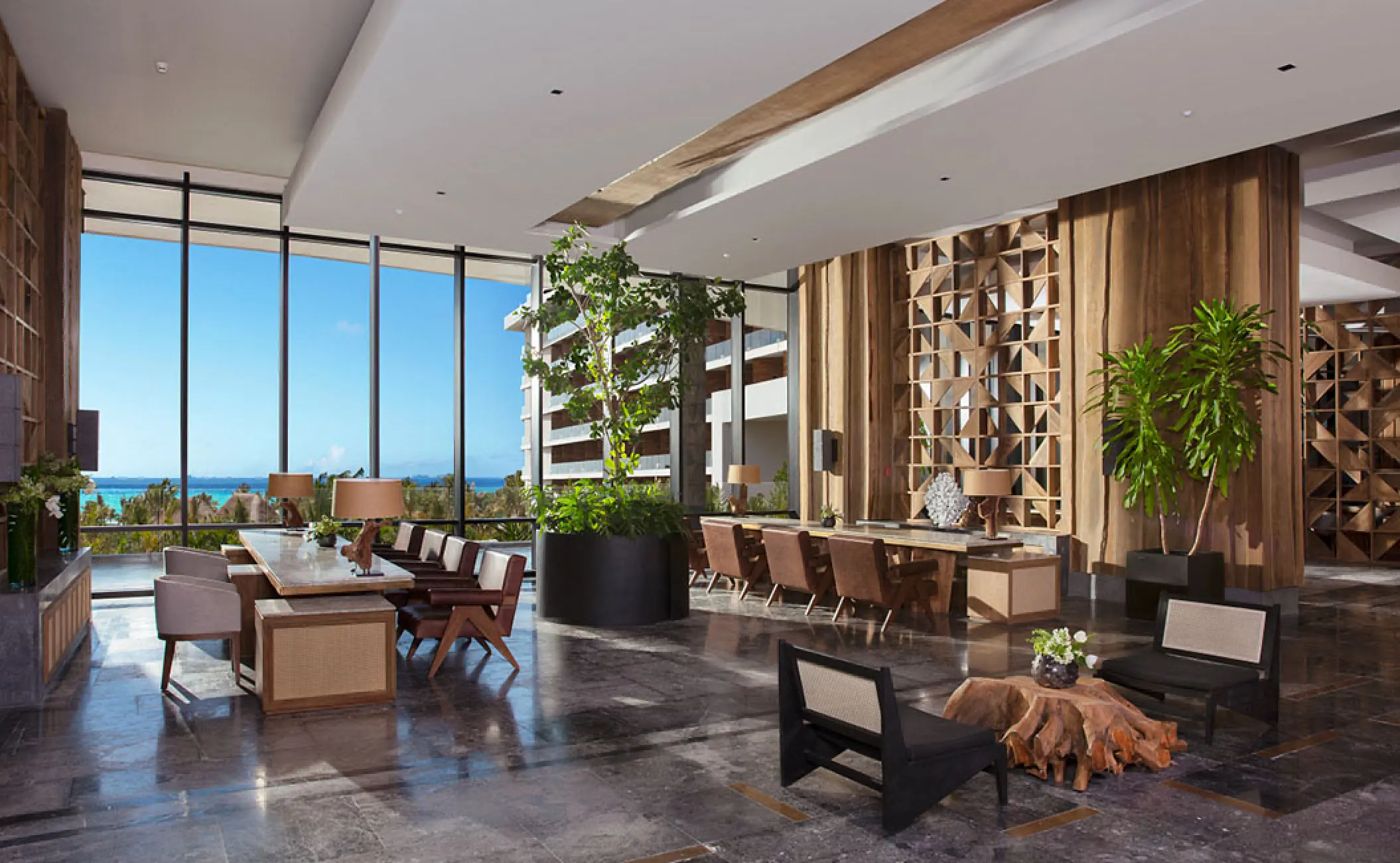 Modern lobby seating area with floor-to-ceiling windows at Secrets Moxche, Playa Del Carmen
