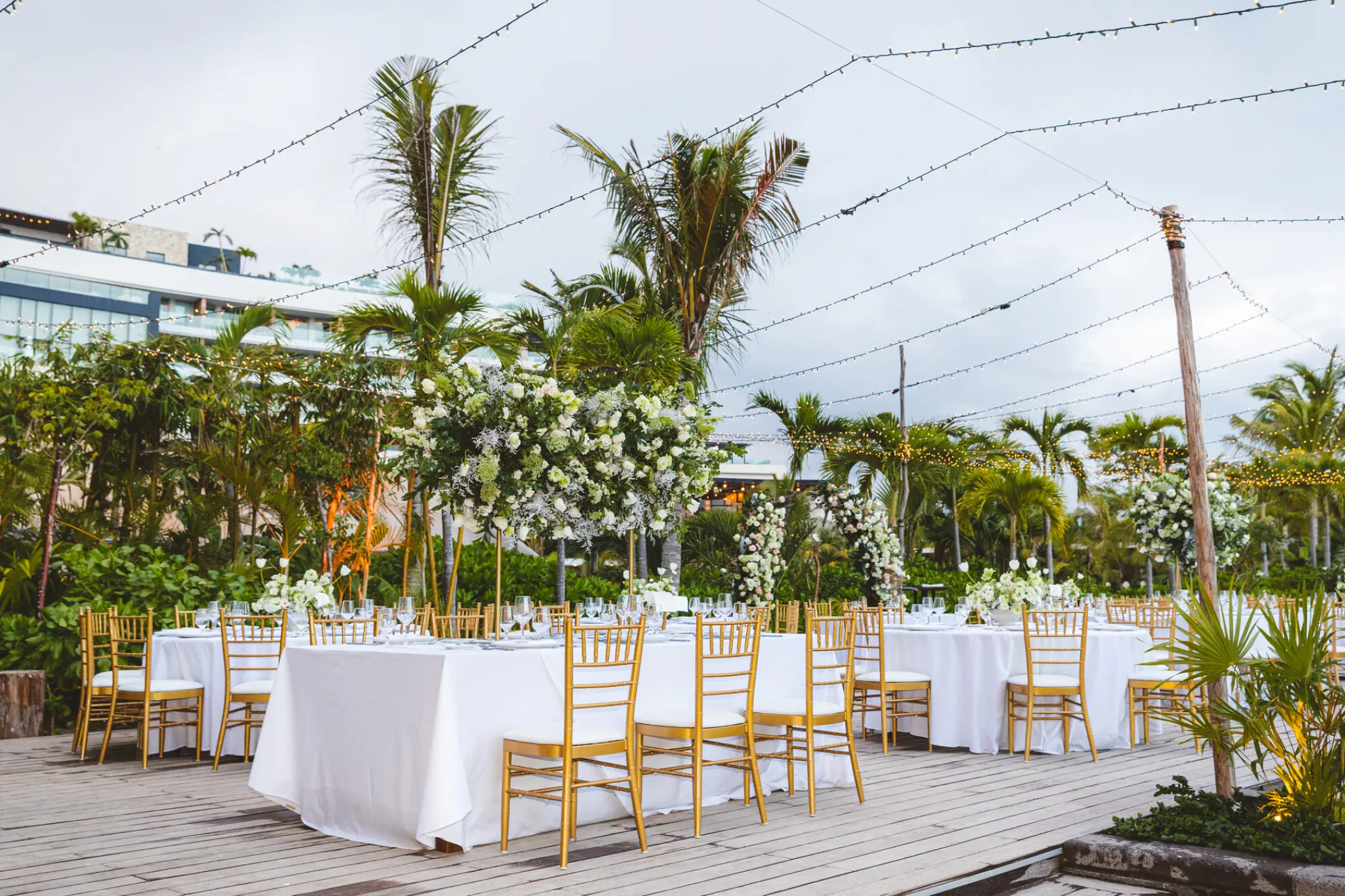 Outdoor wedding reception with white linens and gold chairs at Secrets Moxche, Playa Del Carmen