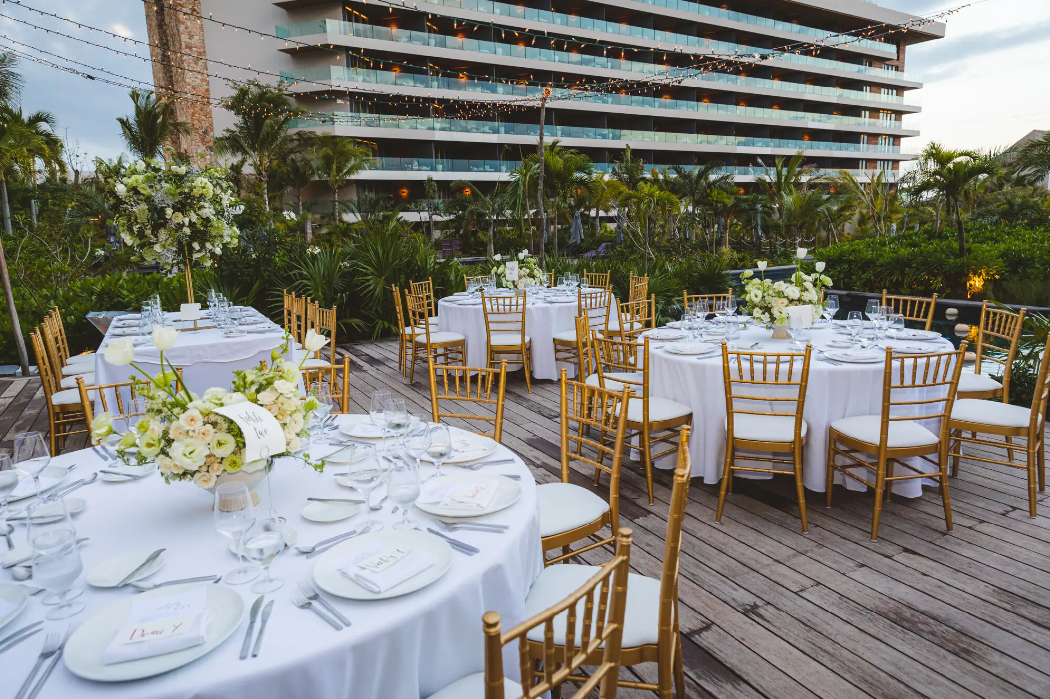 Outdoor wedding reception with gold chairs and white linens at Secrets Moxche, Playa Del Carmen