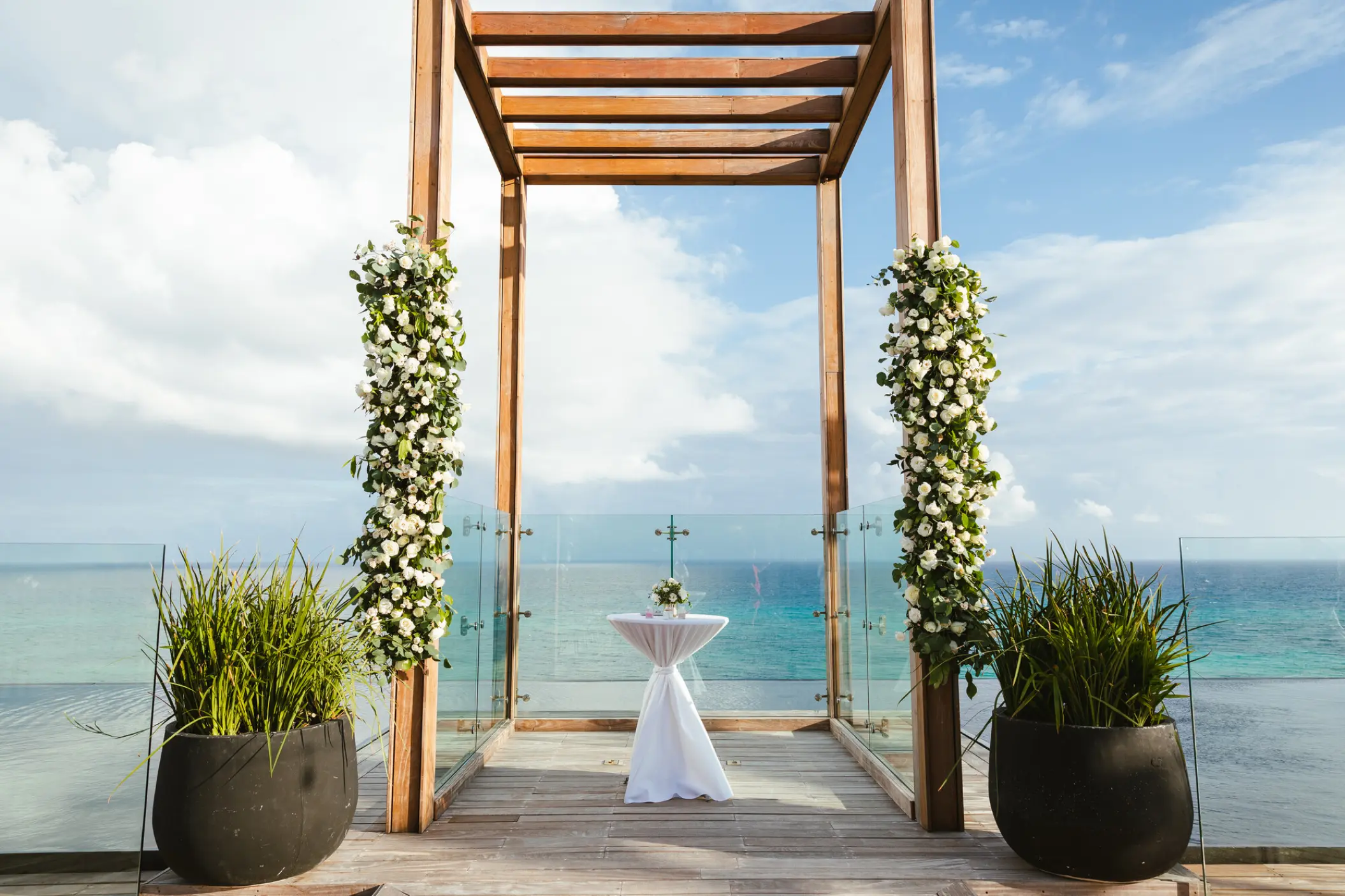 Sky wedding gazebo with white flowers overlooking the ocean at Impression Moxché by Secrets, Playa Del Carmen