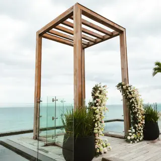 Wooden wedding gazebo with white flowers on a sky terrace at Secrets Moxche, Playa Del Carmen