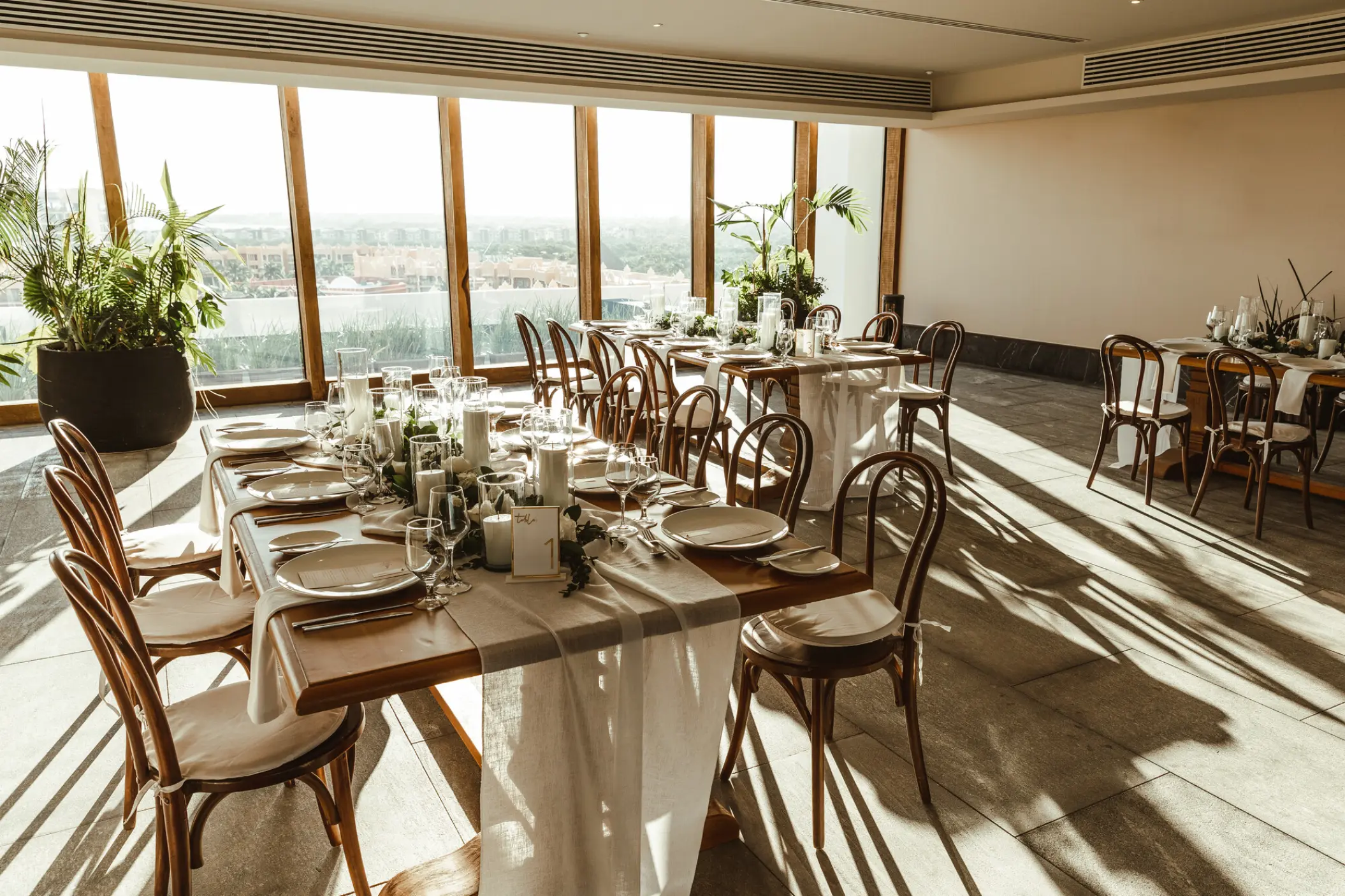 Indoor wedding reception with floor-to-ceiling windows at Secrets Moxche, Playa Del Carmen