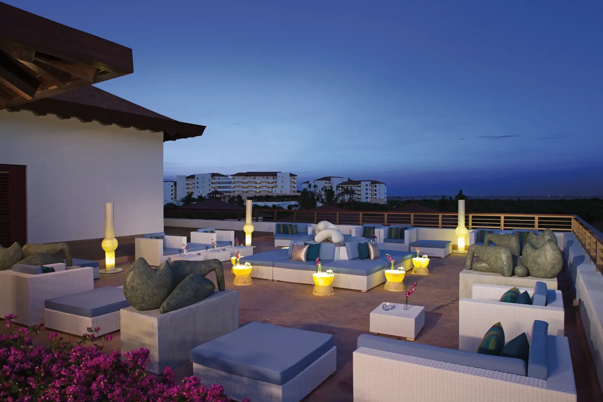 Outdoor lounge and bar terrace with white sofas at Secrets Playa Mujeres, Cancun