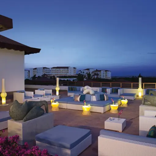 Outdoor lounge and bar terrace with white sofas at Secrets Playa Mujeres, Cancun