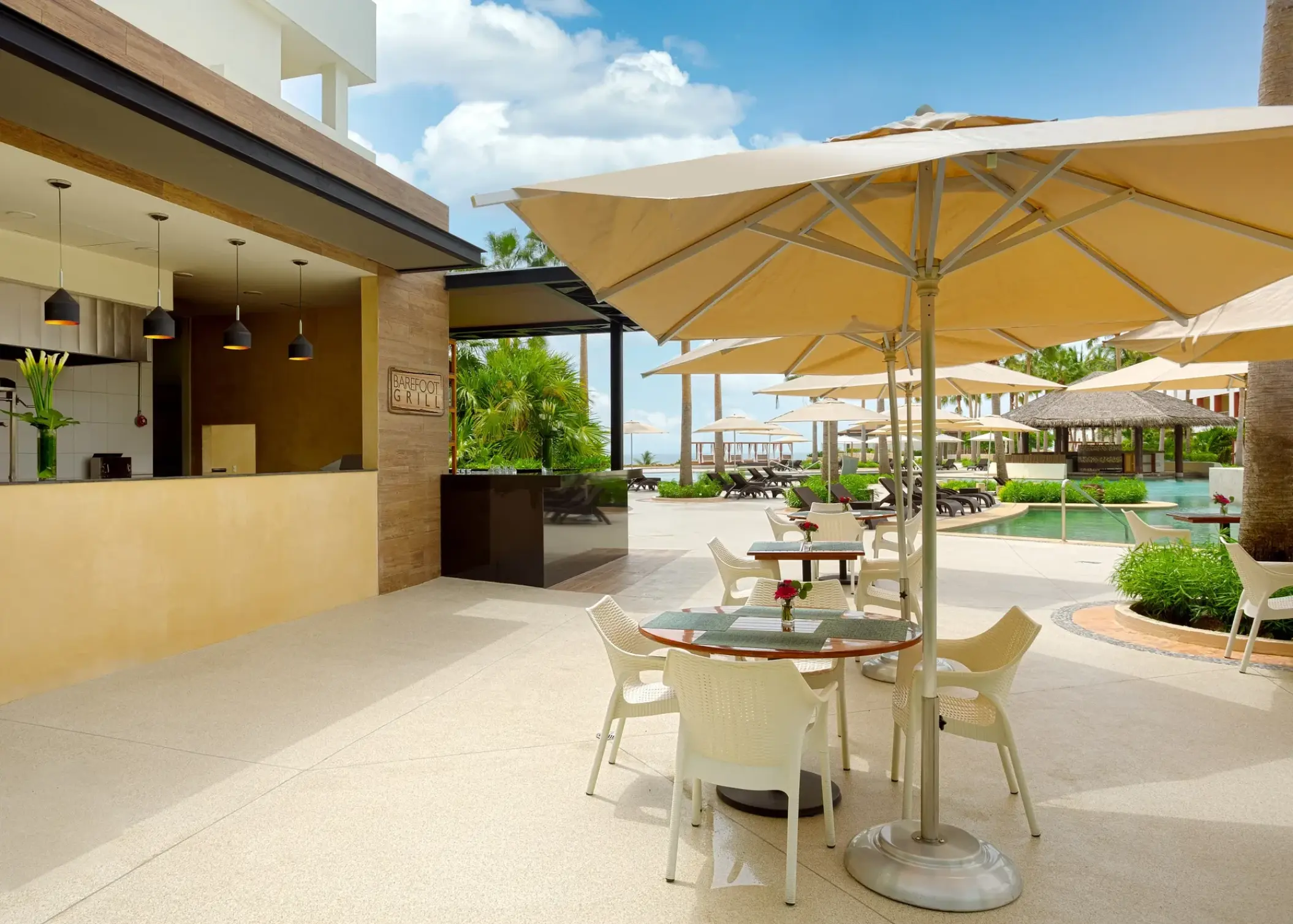 Barefoot Grill outdoor dining terrace with beige umbrellas at Secrets Playa Mujeres, Cancun