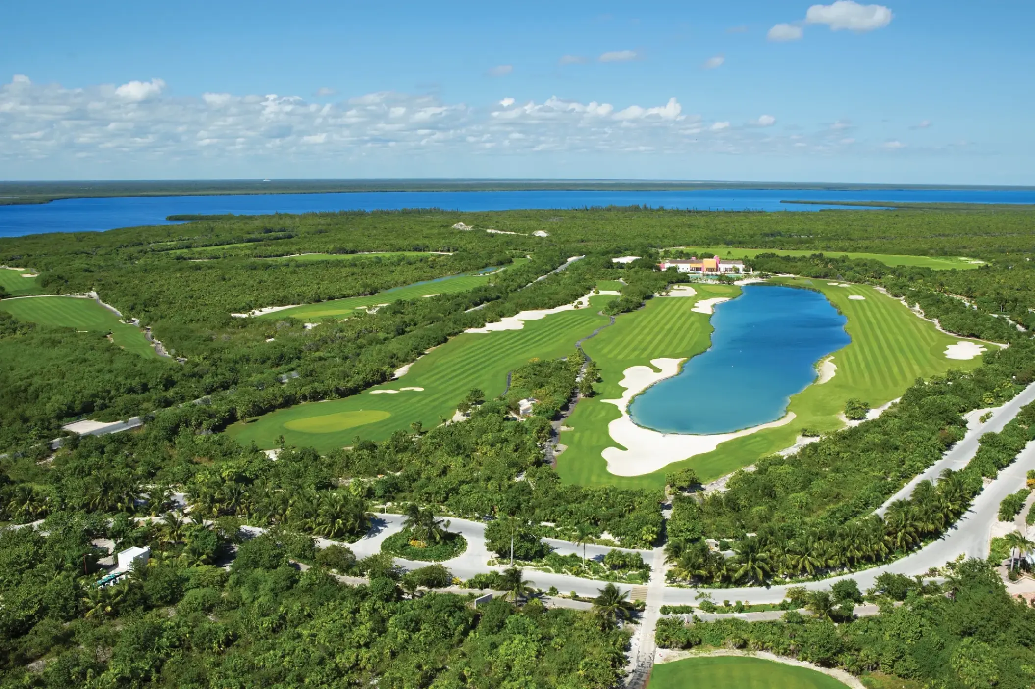 Secrets Playa Mujeres golf course with green fairways and water features, Cancun