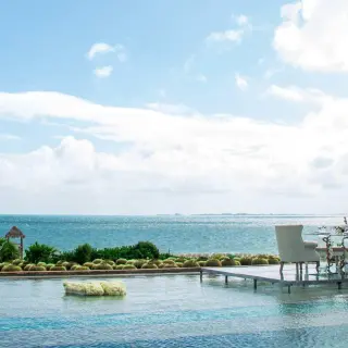 Intimate dinner on the over water infinity pool at Secrets Playa Mujeres Golf and Spa