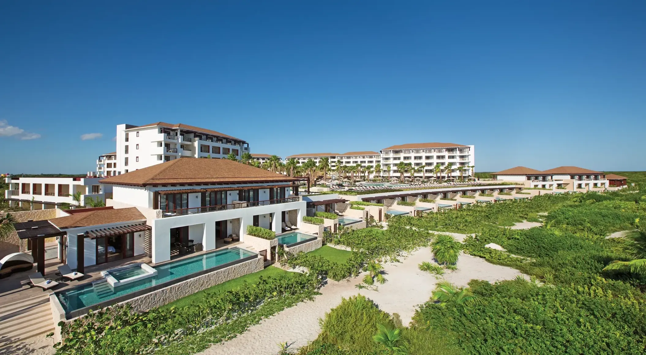 Panoramic view of buildings and swim-up suites at Secrets Playa Mujeres, Cancun