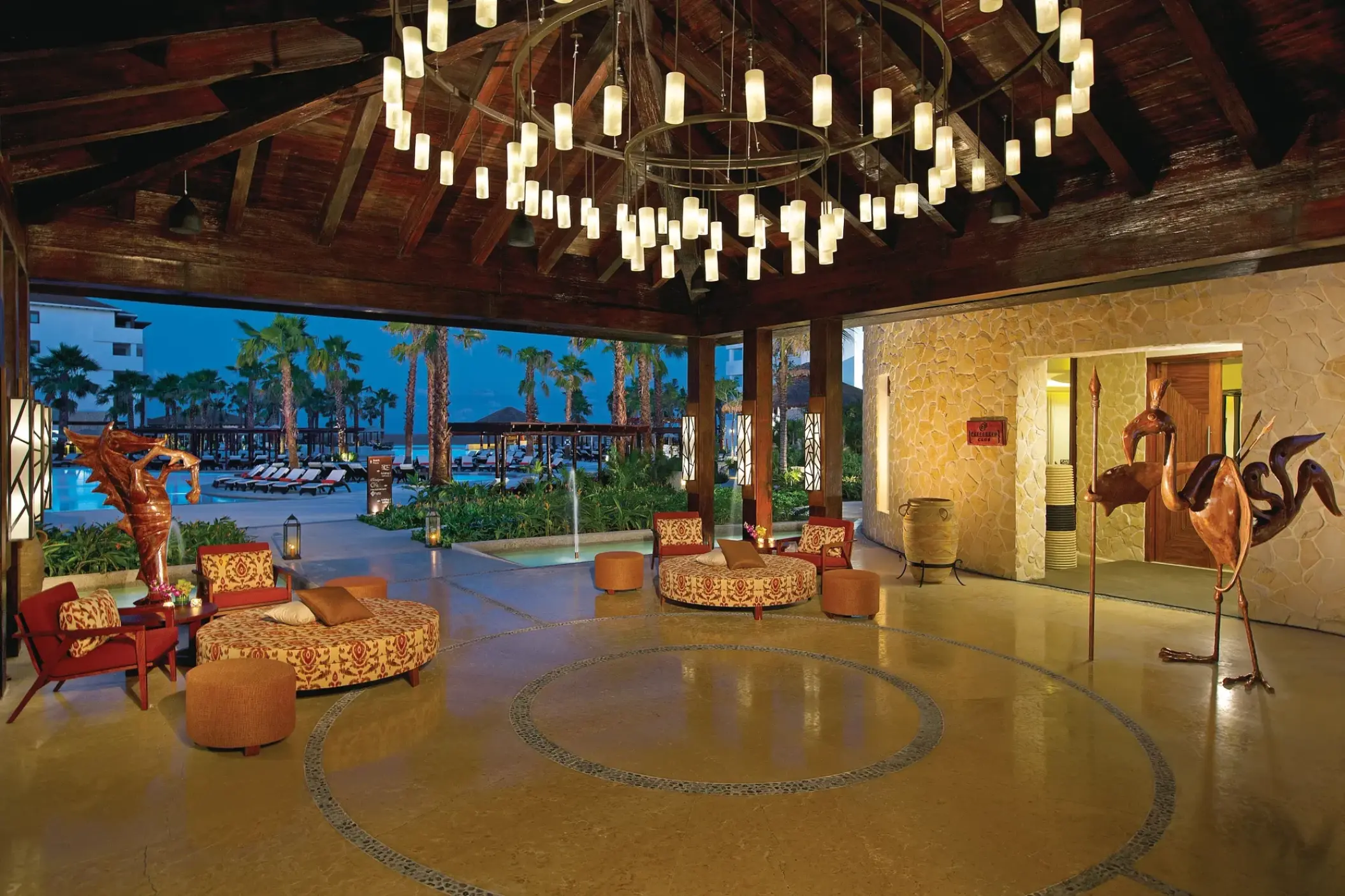 Open-air restaurant lobby with large chandelier at Secrets Playa Mujeres, Cancun