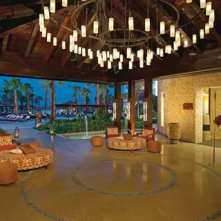 Open-air restaurant lobby with large chandelier at Secrets Playa Mujeres, Cancun