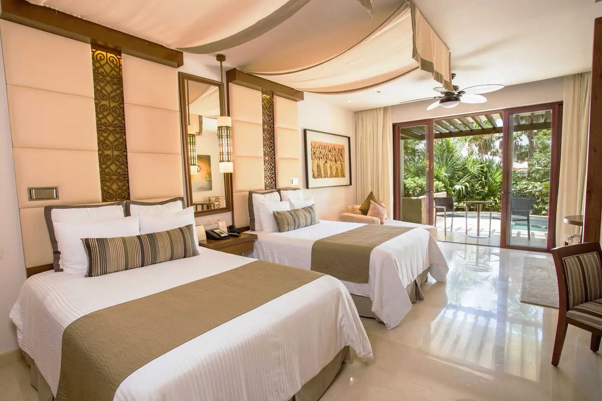 Guest suite with two double beds and garden view terrace at Secrets Playa Mujeres, Cancun