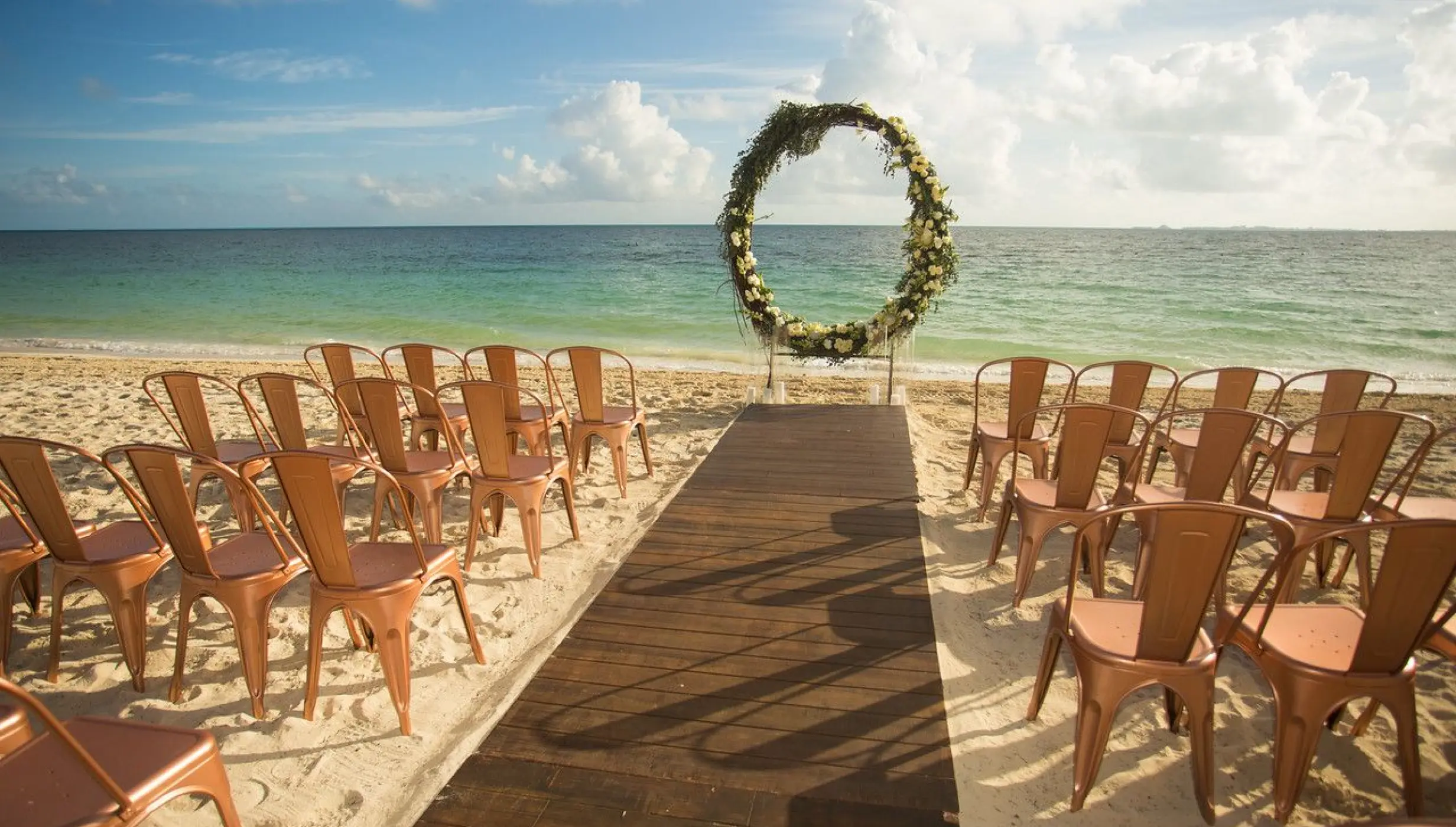 Ceremony decor on the beach wedding venue at Secrets Playa Mujeres Golf and Spa