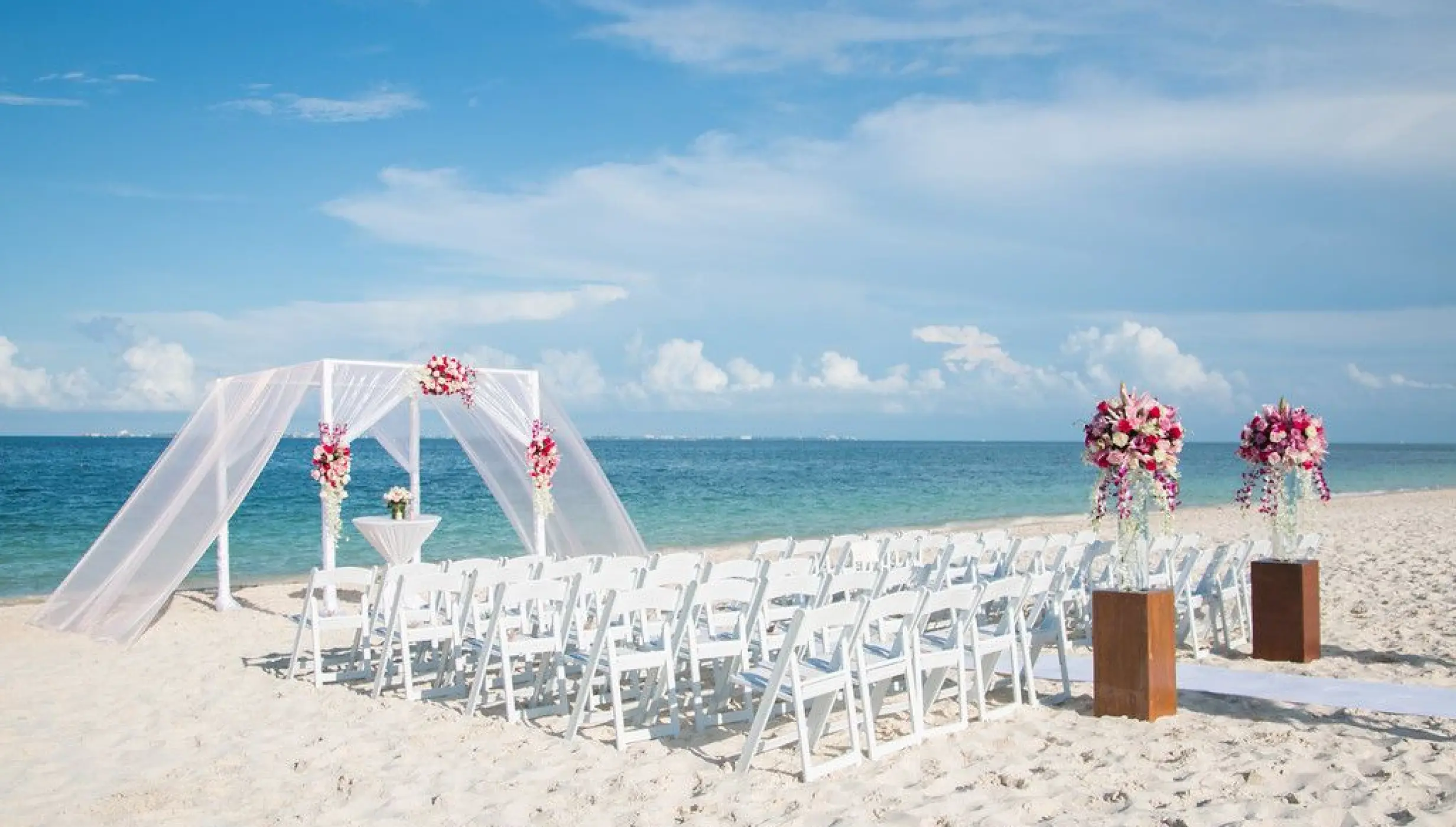 Ceremony decor on the beach wedding venue at Secrets Playa Mujeres Golf and Spa
