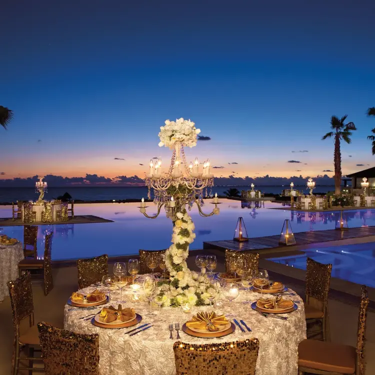 Outdoor wedding reception by the pool at Secrets Playa Mujeres, Cancun