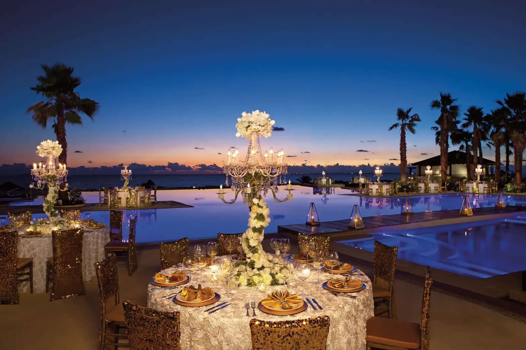 Outdoor wedding reception by the pool at Secrets Playa Mujeres, Cancun