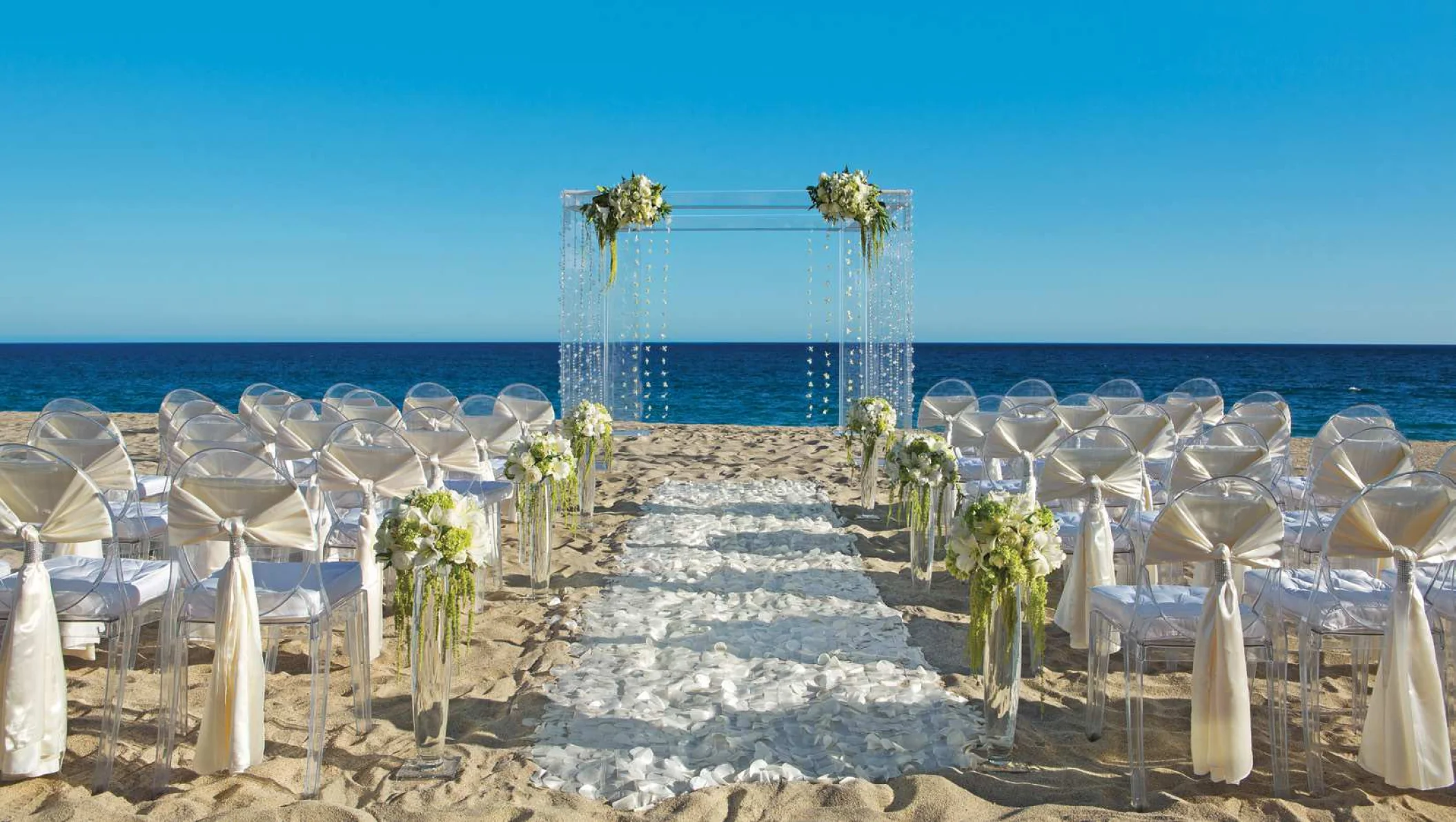 Ceremony decor on the beach wedding venue at Secrets Puerto Los Cabos Golf & Spa Resort
