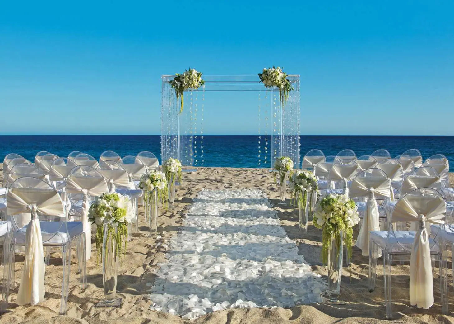 Ceremony decor on the beach wedding venue at Secrets Puerto Los Cabos Golf & Spa Resort