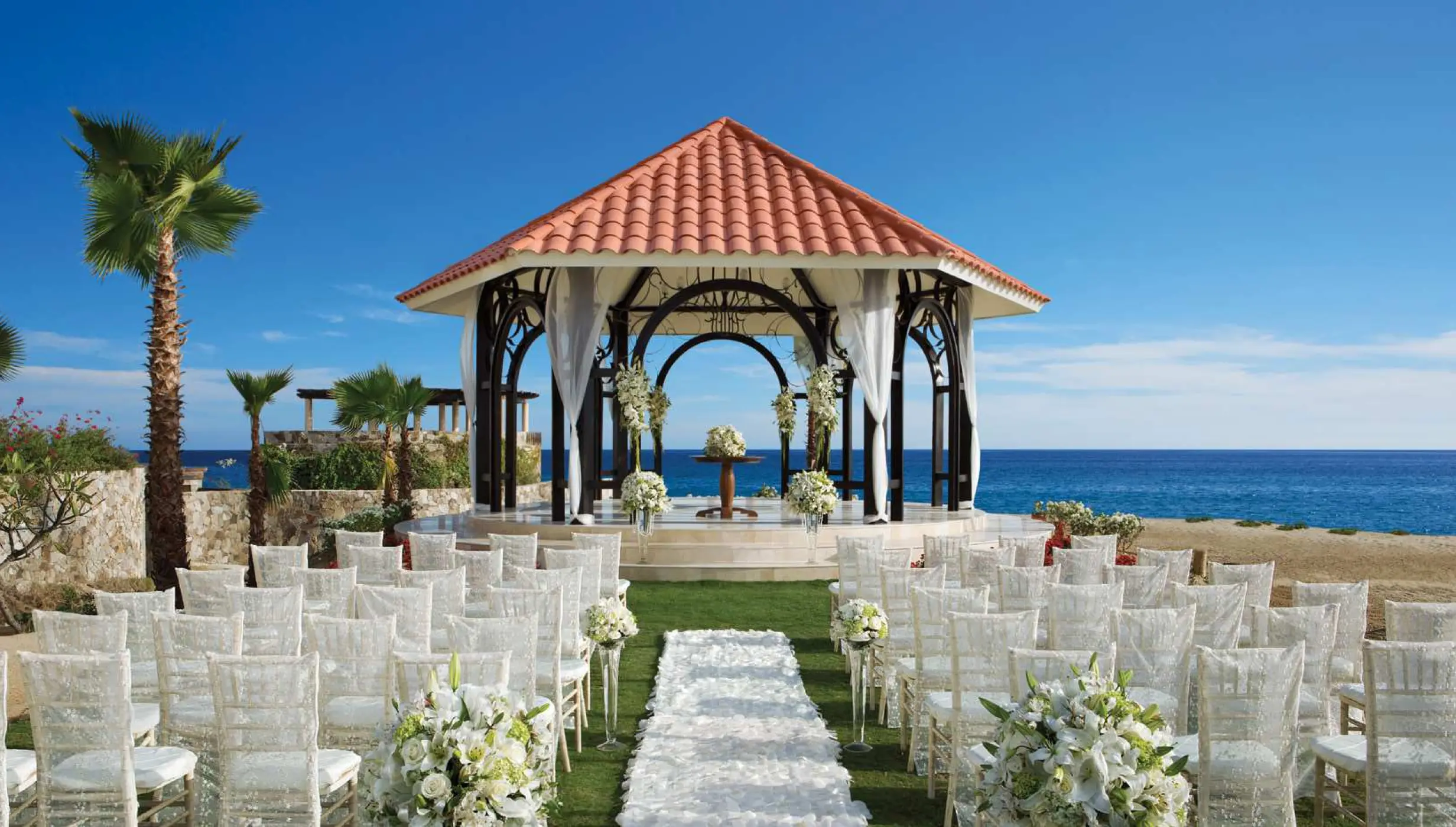 Oceanfront wedding ceremony setup at Secrets Puerto Los Cabos, Cabo San Lucas