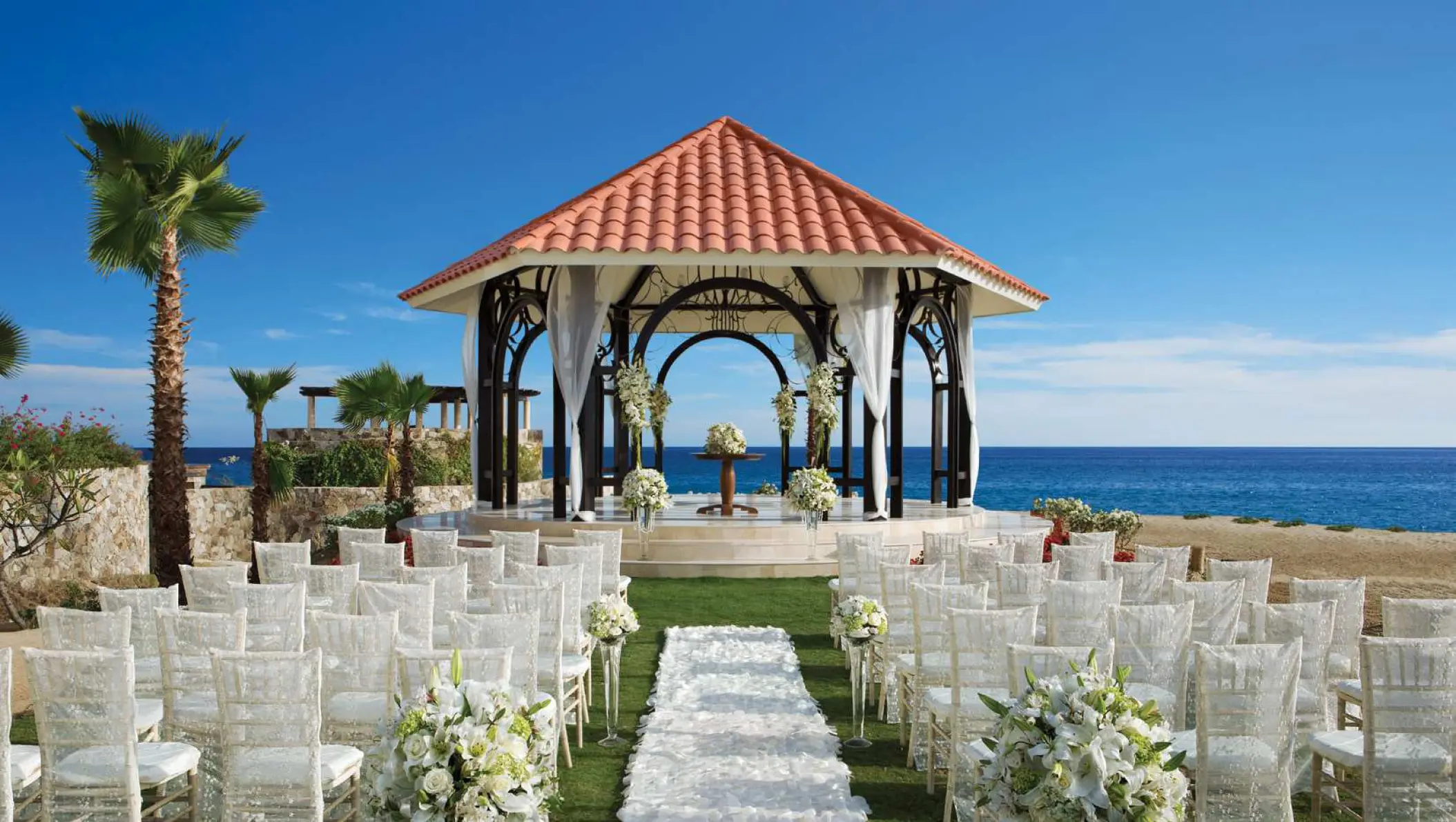 Oceanfront wedding ceremony setup at Secrets Puerto Los Cabos, Cabo San Lucas