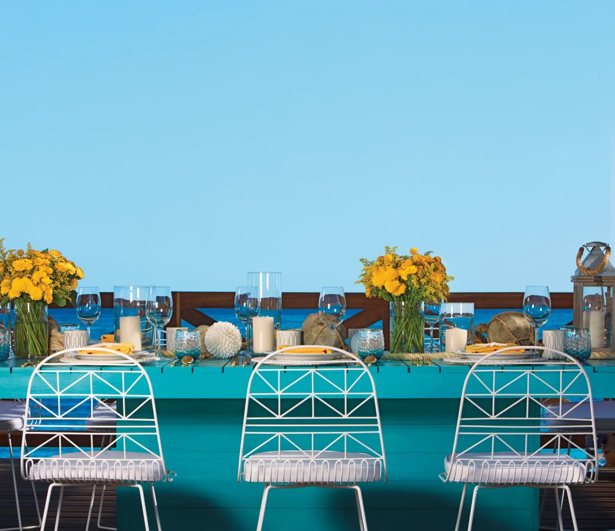 Wedding reception table setup with yellow floral centerpieces at Secrets Puerto Los Cabos, Cabo San Lucas