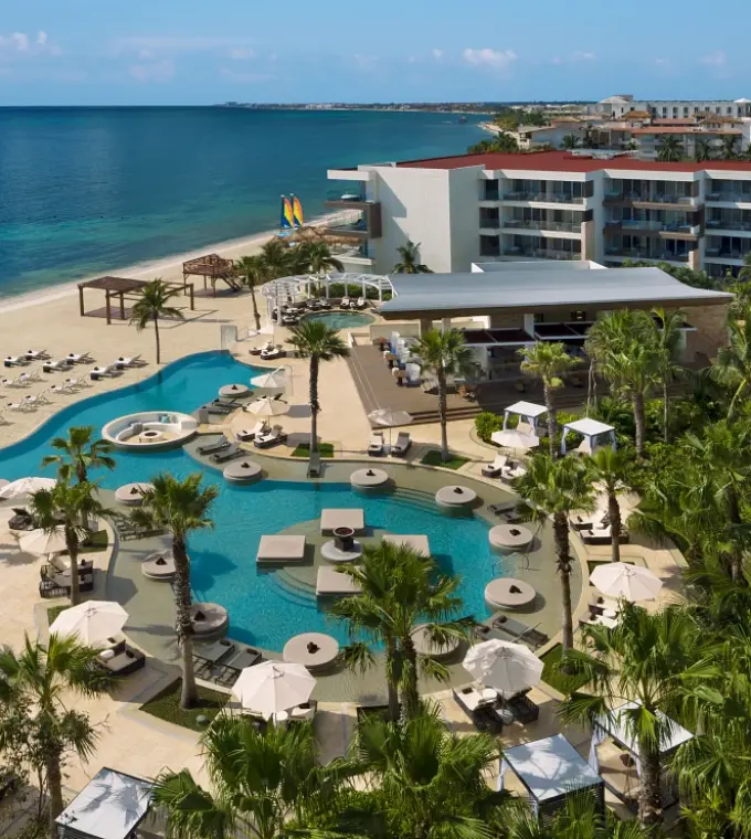 Aerial view of beachfront pools and grounds at Secrets Riviera Cancun, Riviera Maya