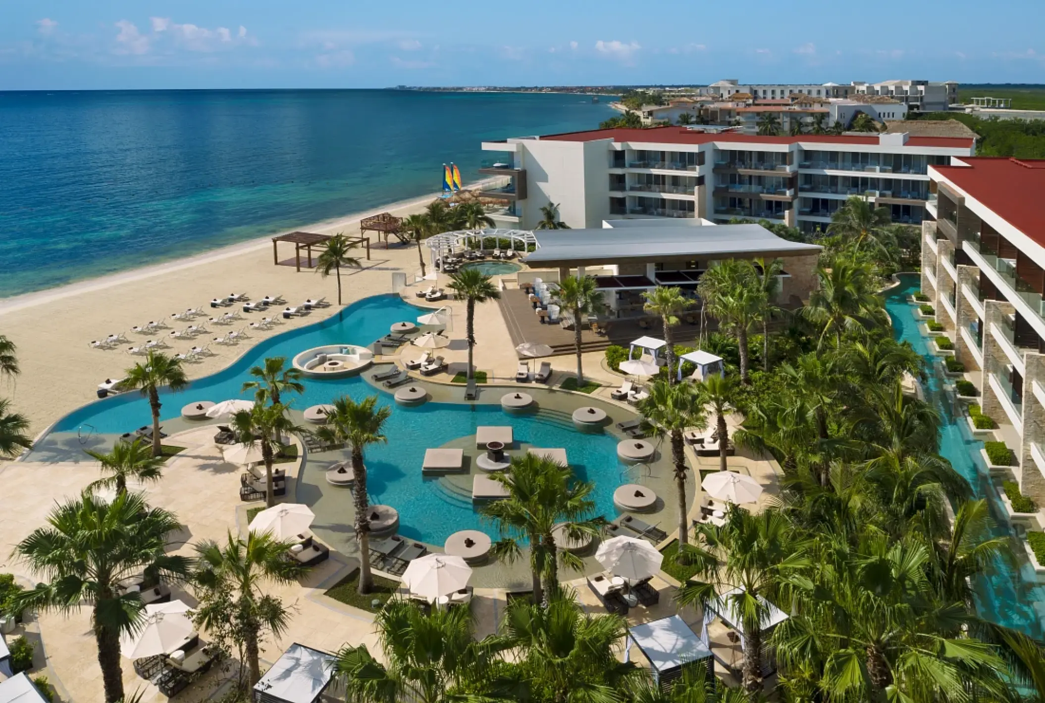 Aerial view of beachfront pools and grounds at Secrets Riviera Cancun, Riviera Maya