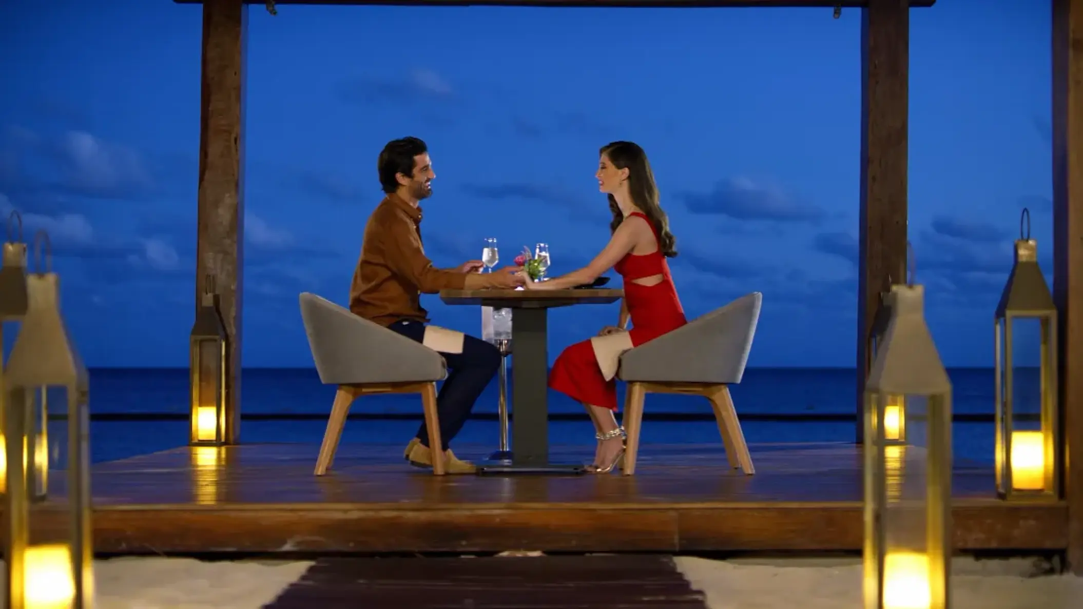 Couple enjoying a private romantic dinner on a wooden deck at Secrets Riviera Cancun, Riviera Maya