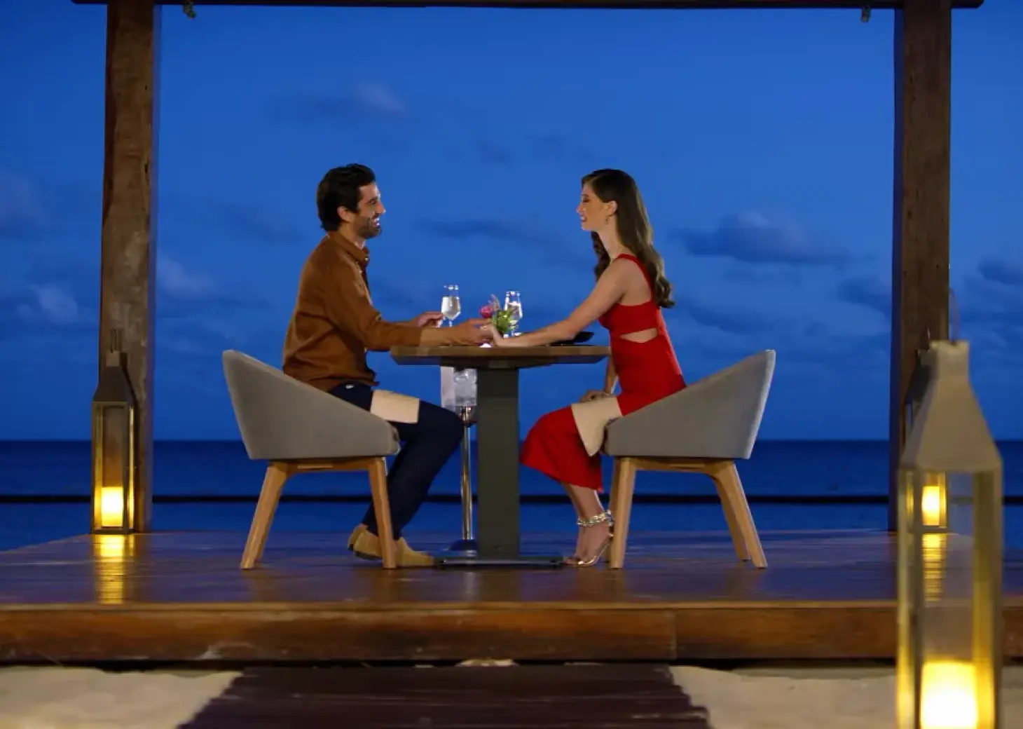 Couple enjoying a private romantic dinner on a wooden deck at Secrets Riviera Cancun, Riviera Maya