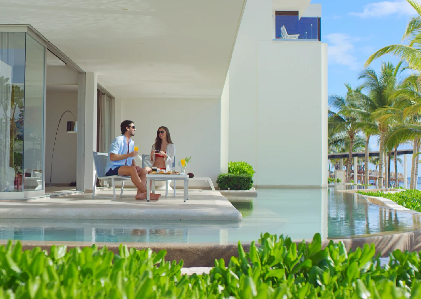 Couple on their terrace room at Secrets Riviera Cancun