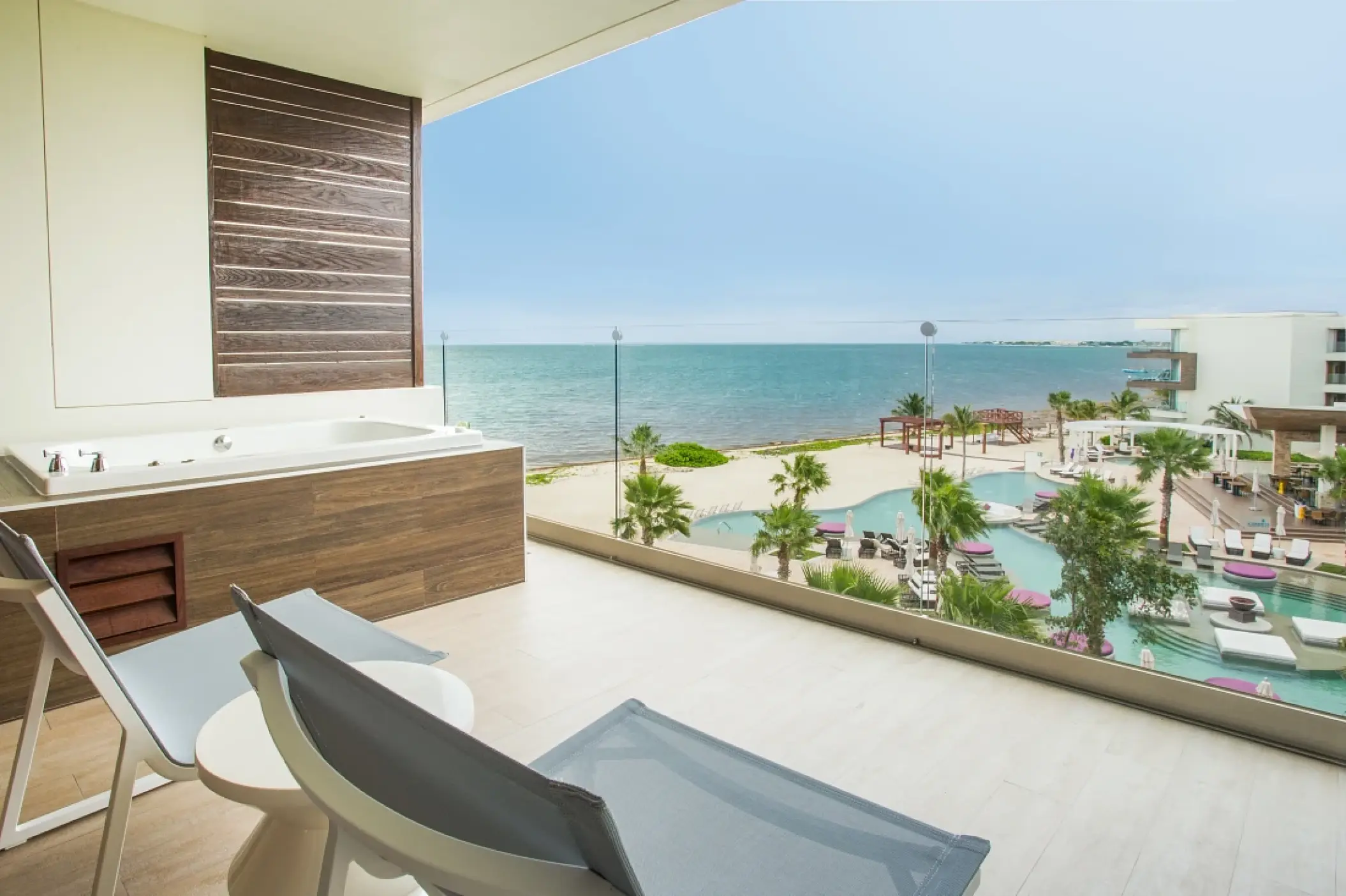 Private balcony with whirlpool tub overlooking the ocean and pool at Secrets Riviera Cancun, Riviera Maya