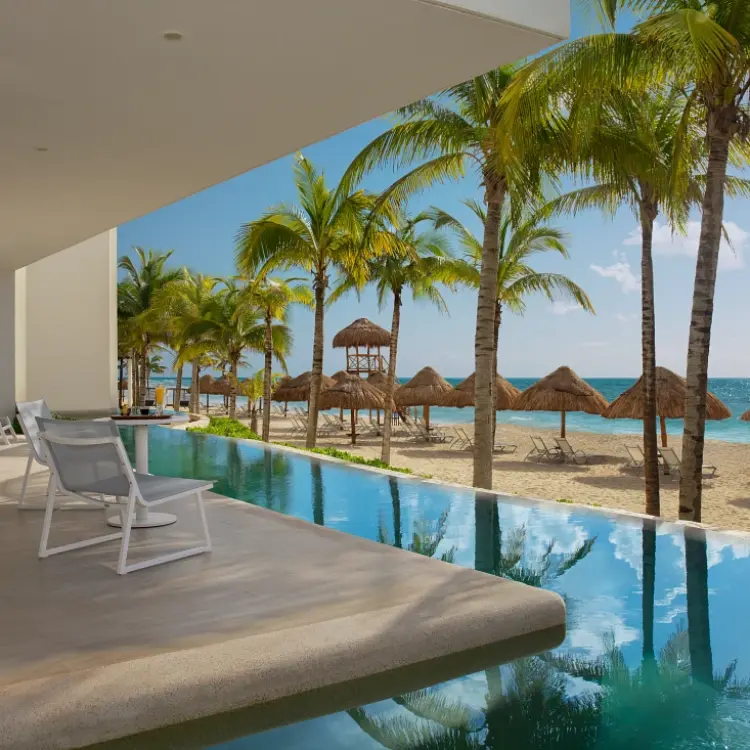 Secrets Riviera Cancun swim-out suite terrace overlooking the beach and palm trees, Riviera Maya
