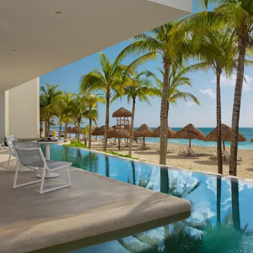Secrets Riviera Cancun swim-out suite terrace overlooking the beach and palm trees, Riviera Maya