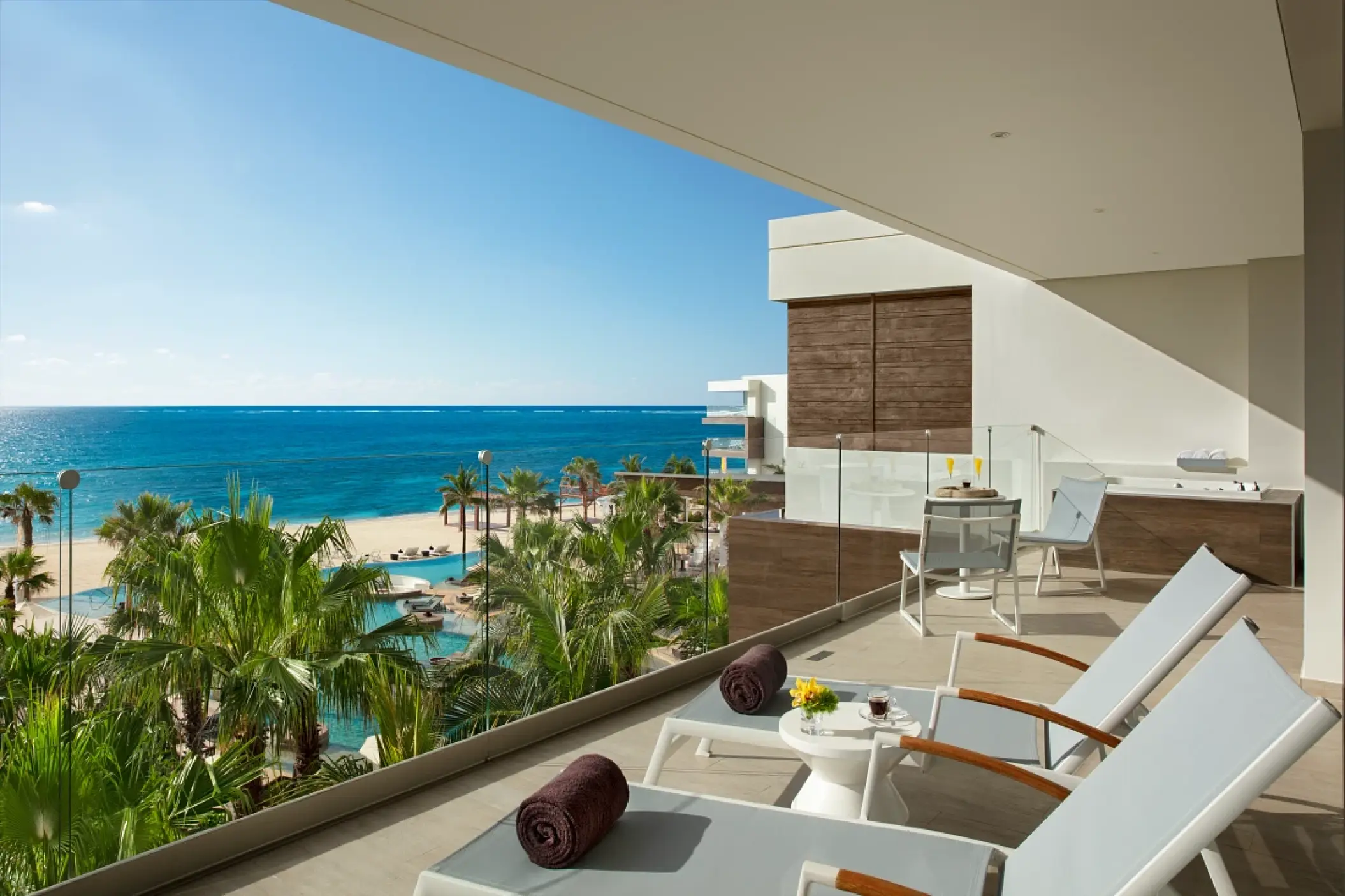 Private suite terrace with lounge chairs overlooking the ocean at Secrets Riviera Cancun, Riviera Maya