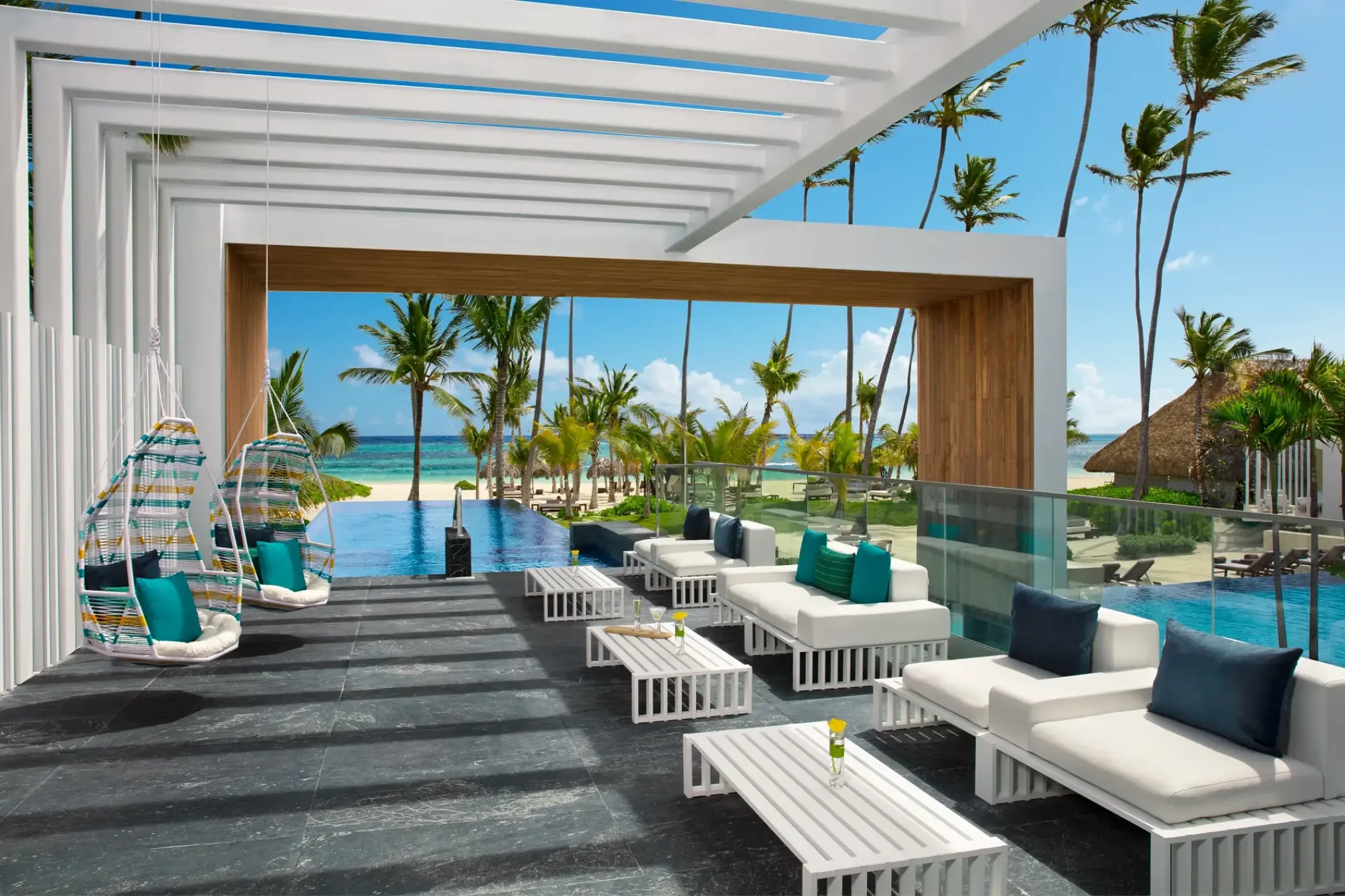 Secrets Royal Beach Punta Cana solarium and infinity pool area under a white pergola, Punta Cana