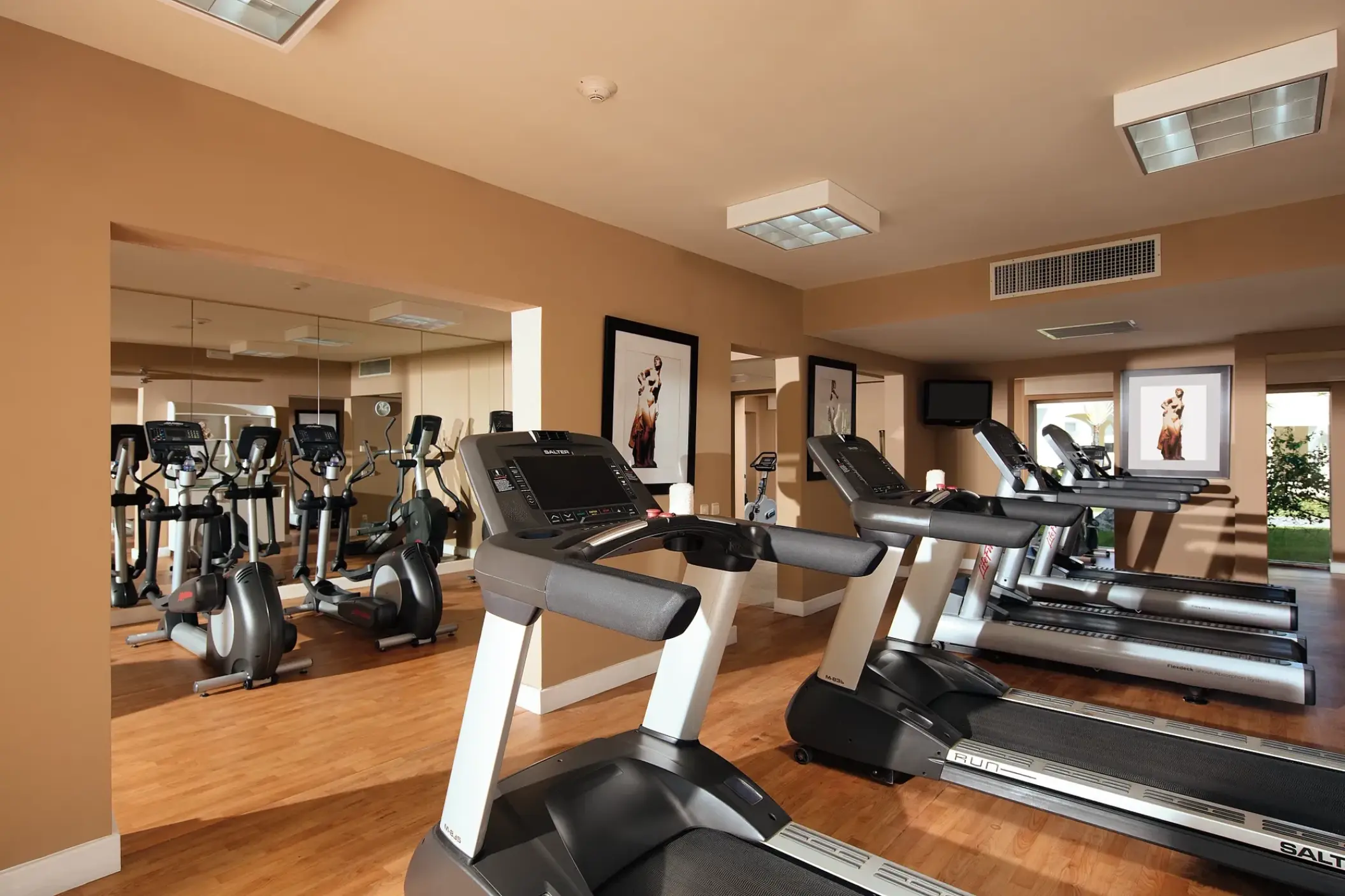Fitness center with treadmills and ellipticals at Secrets Royal Beach, Punta Cana
